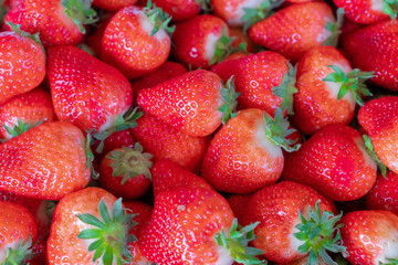 Ripe strawberries on a sunny day. Berries in the market. Texture