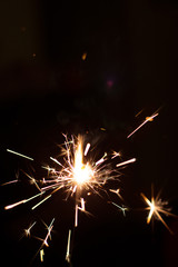 Burning party sparkler on black background