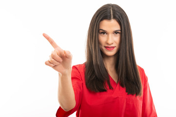 Portrait of beautiful nurse wearing red scrubs showing denial gesture