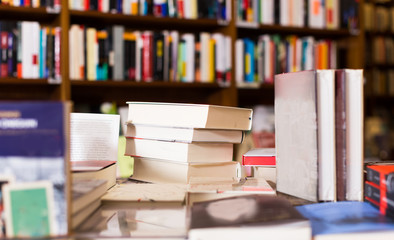 different books lying on table in library