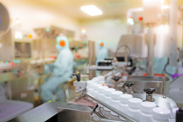 Transfer medicine bottles on the conveyor belt in the pharmaceutical industry, industrial machinery...