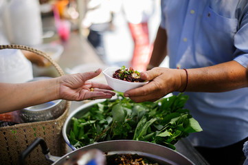Volunteers give food to the poor : donating food is helping human friends in society : Helping People With Hunger With Kindness : the concept of life problems, hunger in society