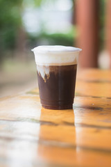 Sparkling Nitro Cold Brew Coffee ready to drink.Outdoor cafe in tropical design.