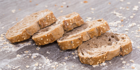 fresh slices of rye bread on wooden surface