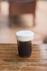 Sparkling Nitro Cold Brew Coffee ready to drink.Outdoor cafe in tropical design.