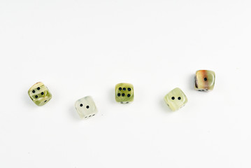 Dices made of natural stone on a white background. Copy space. Gaming.