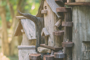 Hand made wooden bird house nest  in public Park , hand wood shelter for birds .