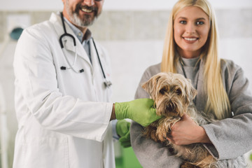 woman holding her dog ta the veterinary clinic
