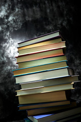 Books on shelf on black background 