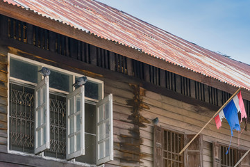 Pigeons on old wooden window of the former wooden house.