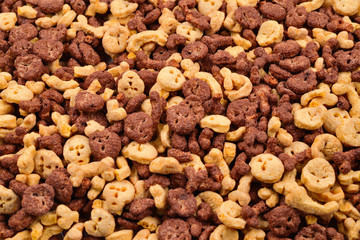  Chocolate flakes in the form of skulls and bones background. Top view.