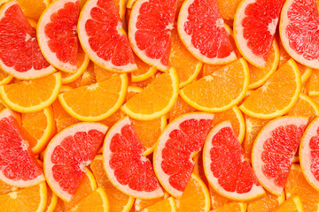 Slices of oranges and a grapefruits as a background.