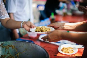 the concept of hope : Hand-feeding to the needy in society : Concept of Feeding : Volunteers give food to the poor : donating food is helping human friends in society