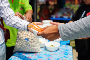 The concept of food is essential to life : the concept of hope : Hand-feeding to the needy in society : Concept of Feeding : Volunteers give food to the poor