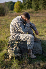 The soldier sits and rests. Sad and Tired soldier. Soldier	