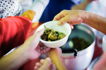 The concept of food is essential to life : the concept of hope : Hand-feeding to the needy in society : Concept of Feeding : Volunteers give food to the poor