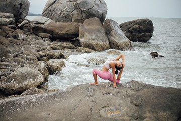Asian girl practice Yoga on the beach Sunrise morning day