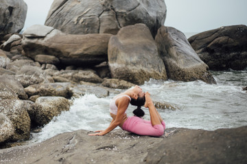Asian girl practice Yoga on the beach Sunrise morning day