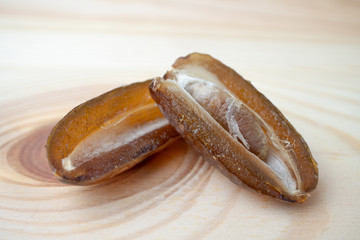 Dried of sweet dates palm fruits on wooden plate. Dates is a dried fruit that provides high energy.