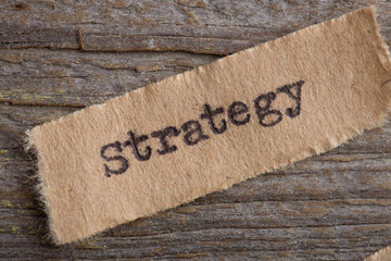 Strategy word on a piece of paper close up, business creative motivation concept