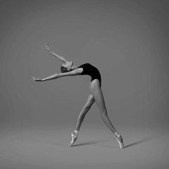 Ballerina makes a back arch. Black and white photo.