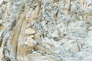 Steep clay rock with sharp edges, covered with many cracks and chips