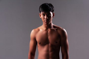 Fototapeta premium The handsome man show body muscle,from exercise,looking straight,good health,blurry light around