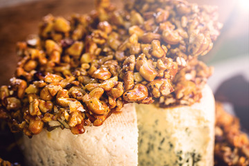 Tasty gorgonzola cheese with praline, cheese dish decorated for events, typical food at social events like weddings and high society parties.