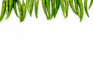 Fresh green chilli pepper as food ingredient on white table background top view mockup