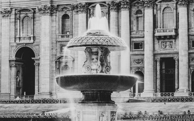 Illuminated Bernini Fountain at St Peters Basilica in the evening dusk. St Peters Square, Vatican