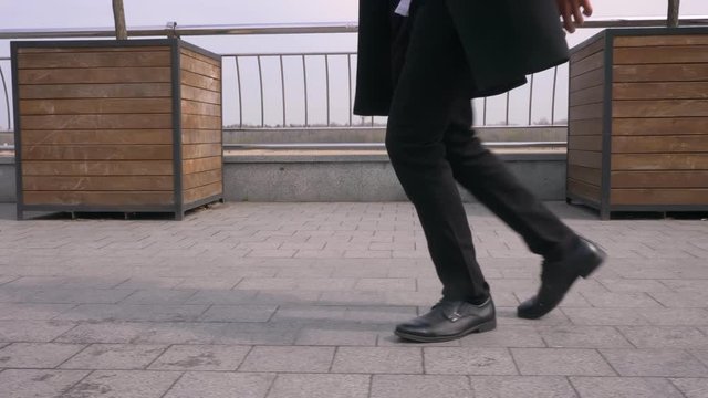 Closeup portrait of young attractive african american businessman making a moonwalk on the street in the urban city