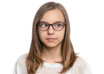 Crazy child making grimace - Silly face. Funny caucasian teen girl in eyeglasses, isolated on white background. Close-up portrait. - obrazy, fototapety, plakaty