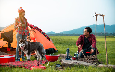 Couple travel camping in countryside with campfire, Great warm evening, camping concept.