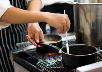 Chef preparing food in the kitchen, chef cooking, closeup
