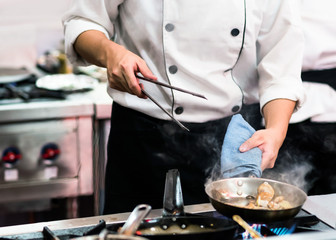 Chef preparing food in the kitchen, chef cooking, closeup