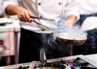 Chef preparing food in the kitchen, chef cooking, closeup