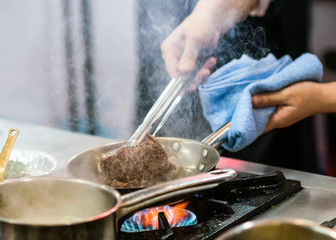 Chef preparing food in the kitchen, chef cooking, closeup