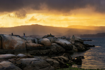 Coastal rocks on stormy sunset