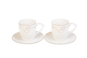 Two white porcelain tea, coffee cups with saucer. Isolated on white