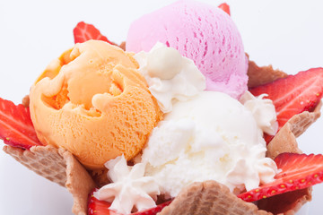 Set of ice cream scoops of different colors and flavours. Decorated with strawberries. Delicious dessert