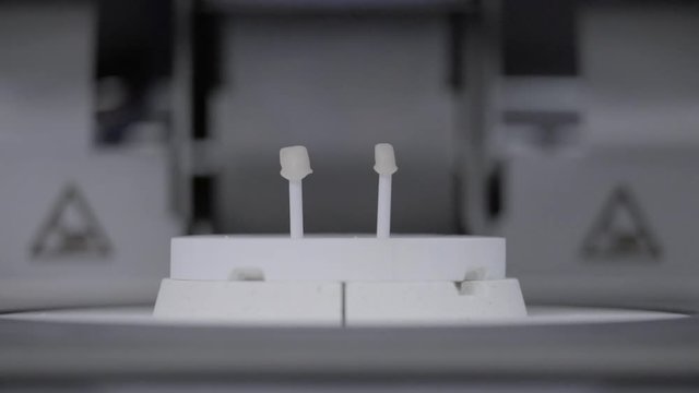 Artificial teeth in extremely high temperature oven in dental clinic. Dental technician bakes ceramic teeth in special furnace machine. Teeth reconstruction process in dental laboratory by technician