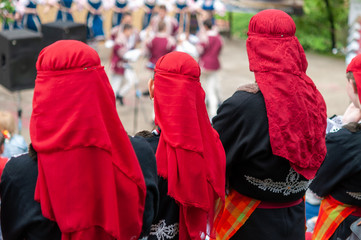 People in traditional costumes dance bulgarian