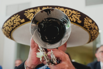 Mexican musician with his trumpet in the foreground, mariachis.