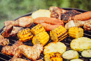 Various meats and vegetables on the grill
