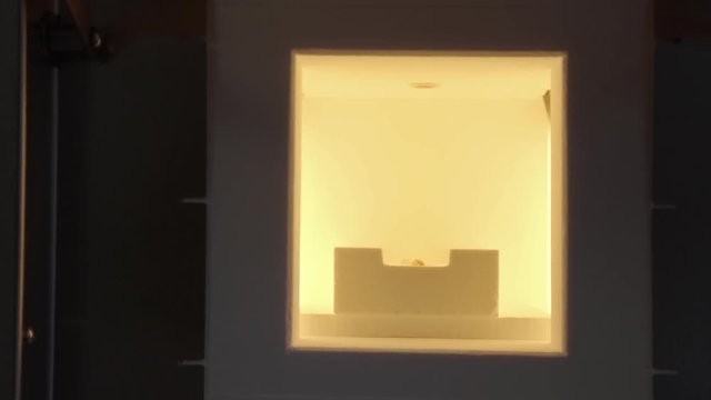 Close up of baking artificial teeth in extremely high temperature oven in dental laboratory. Dental technician bakes ceramic teeth in special furnace machine