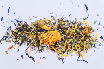 Dry tea from useful herbs and flowers on a light background