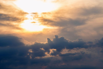Evening skyscape with dark orange clouds and sun for natural background