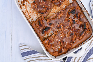 Chocolate cake with salt and caramel cookies on a white background. Traditional American dessert cut into portions. Free space for text. Copy space.