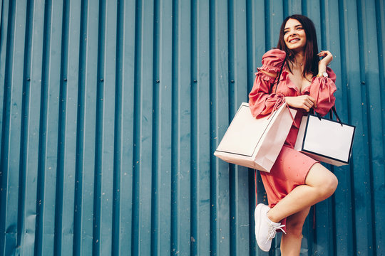 Young and happy woman shooping, blue background. Love girl. Summer shooping.