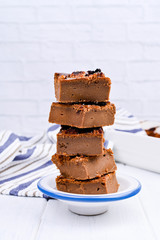 Chocolate cake with salt and caramel cookies on a white background. Traditional American dessert cut into portions. Free space for text. Copy space.